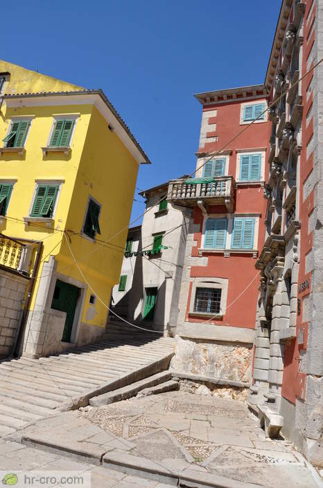 Narrow lane between colourful houses