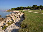 Pošesi - Reinforced stone edge beside a grassy path 