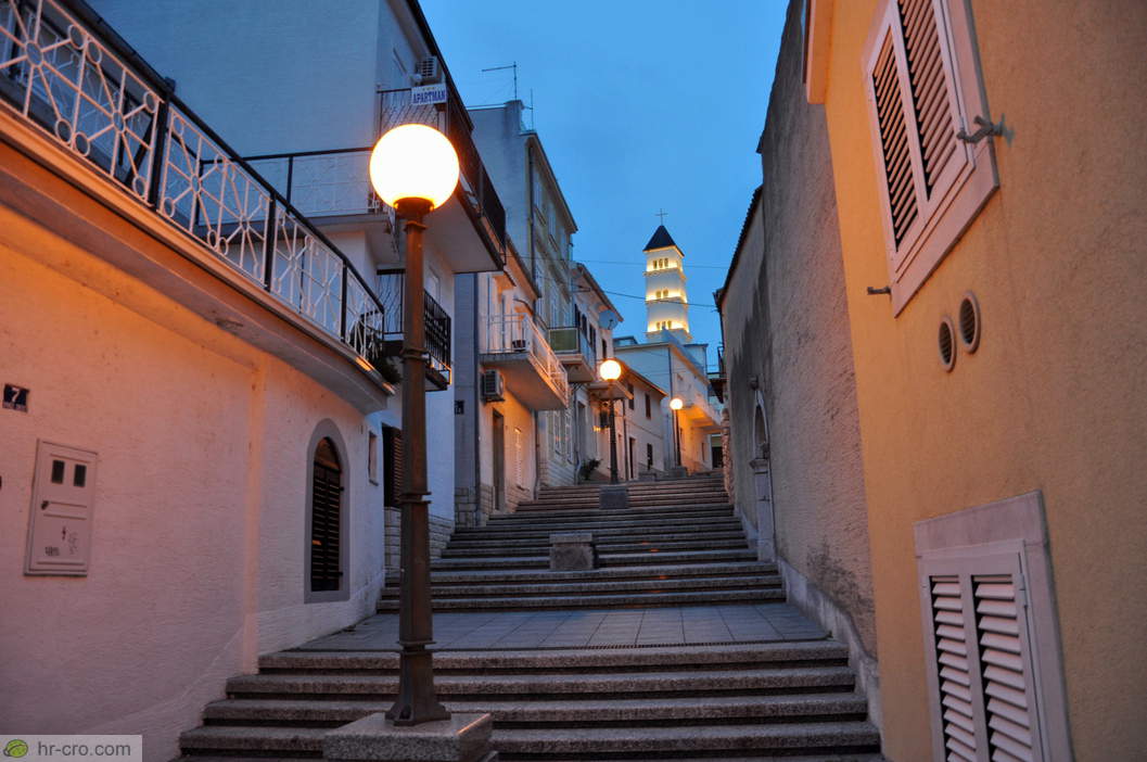 Steps towards the illuminated bell tower of St Anthony’s Church