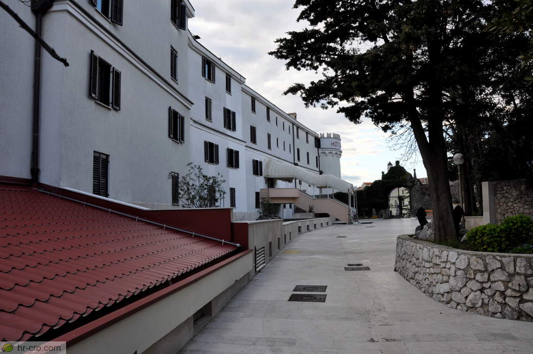 Long monastery wing beside the tree-lined path