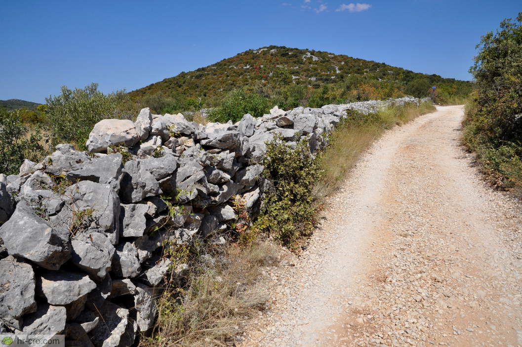 Path beside a high dry-stone wall