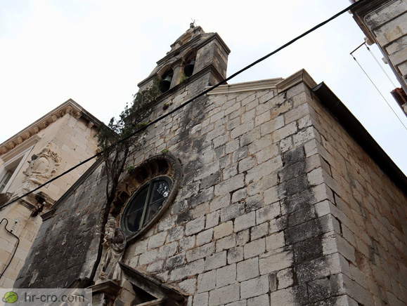 A cypress tree growing above the entrance
