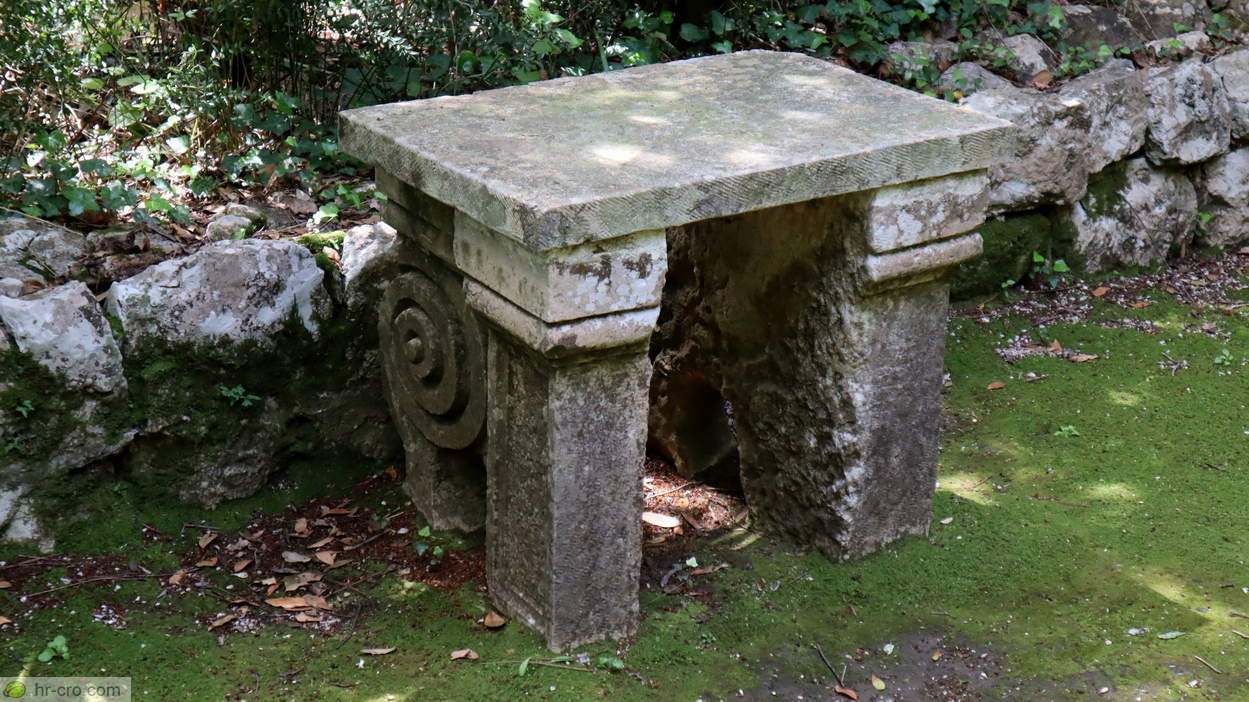 Carved stone table in the wooded garden